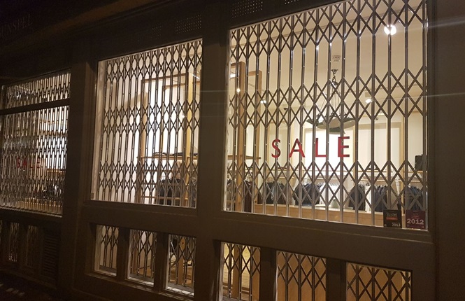 RSG1000 retractable security grilles fitted to a luxury british clothing shop in Redchurch St, Central London.