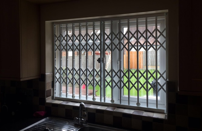 RSG1000 retractable grille securing the kitchen window of a house in Harlow.